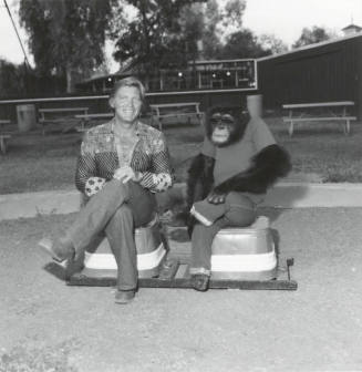 Chimpanzee and trainer at Legend City. - July 1977