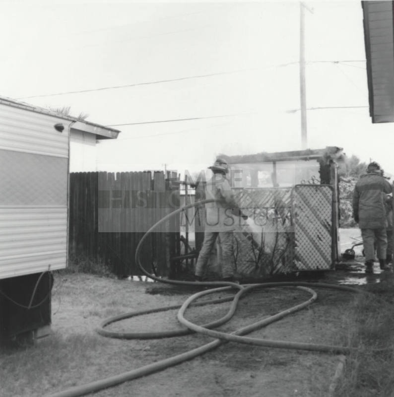 Two Firefighters put out fire in fence