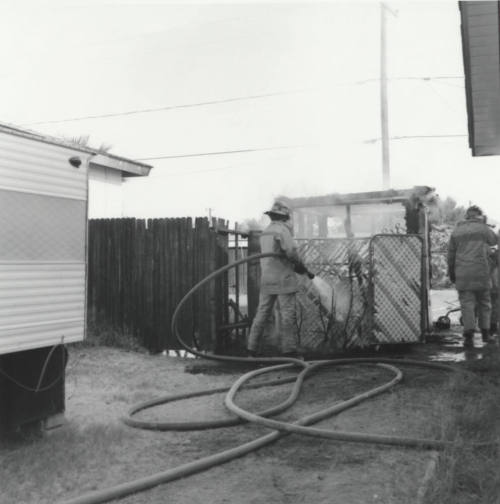 Two Firefighters put out fire in fence