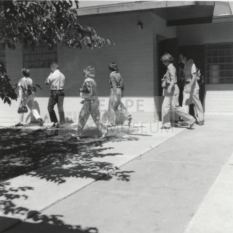 Unidentified People Exiting Building