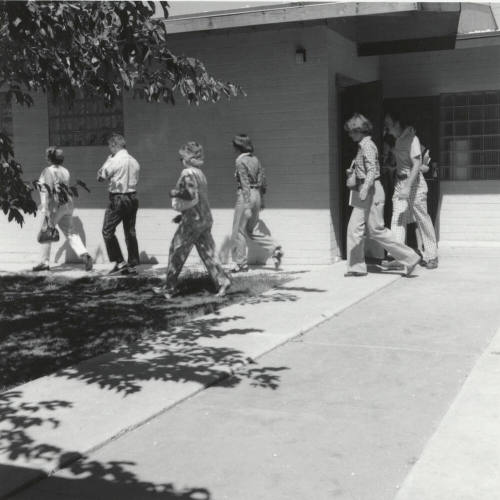 Unidentified People Exiting Building