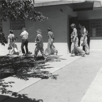 Unidentified People Exiting Building