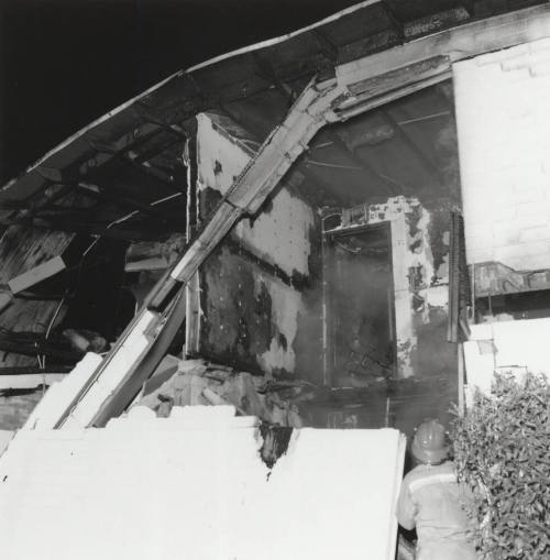 Burnt Building With Firefighter