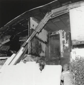 Burnt Building With Firefighter