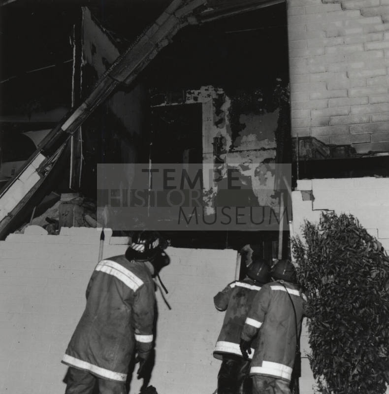 Burnt Building With Three Firefighters
