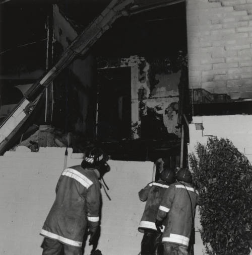 Burnt Building With Three Firefighters