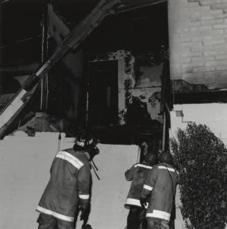 Burnt Building With Three Firefighters