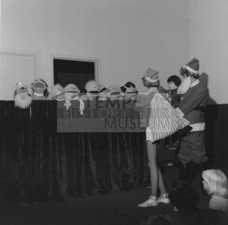 People In Costume And A Row Of Puppets