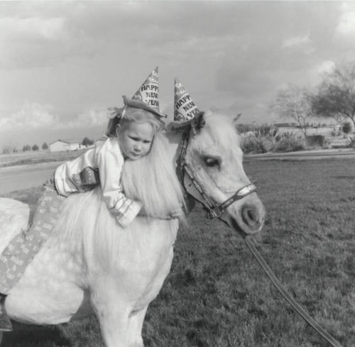 New Year Girl Holding On To Pony