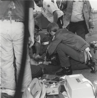 Paramedics Aiding Injured Man
