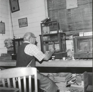 Man at workbench, Jan 1978