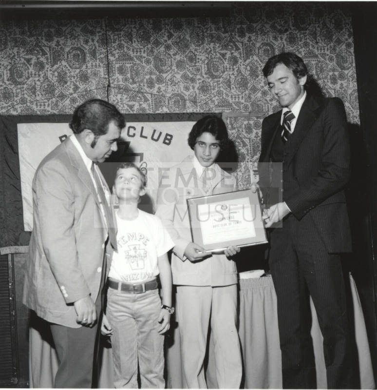 Boy receiving honors with a certificate