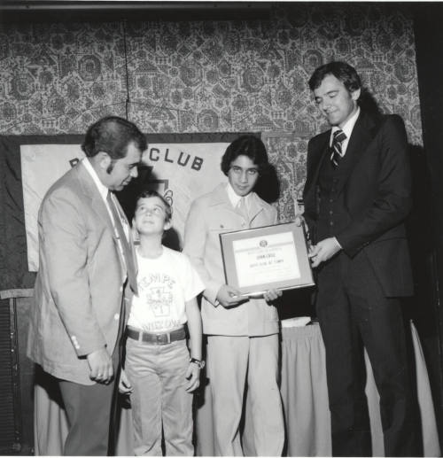 Boy receiving honors with a certificate
