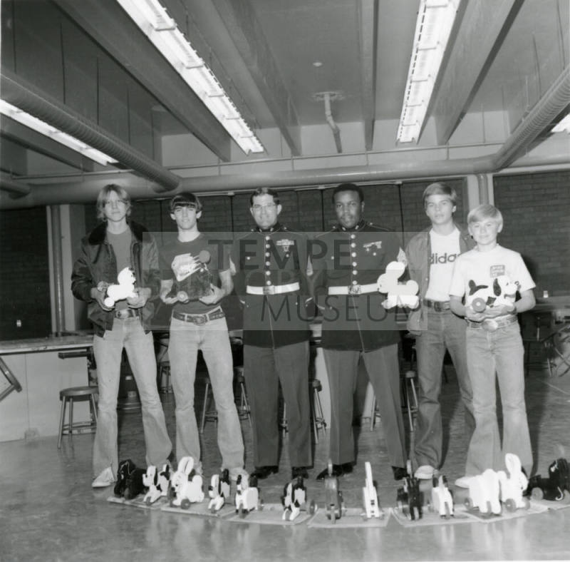 Four young men with two military personell