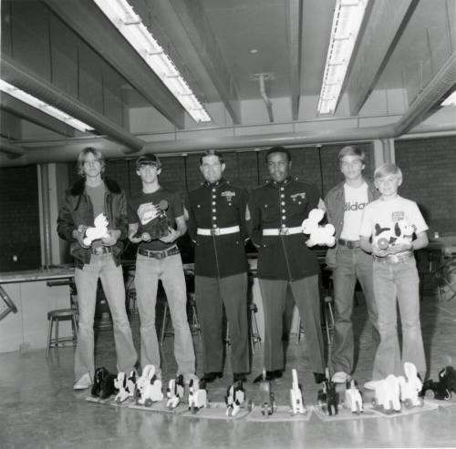 Four young men with two military personell