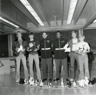 Four young men with two military personell