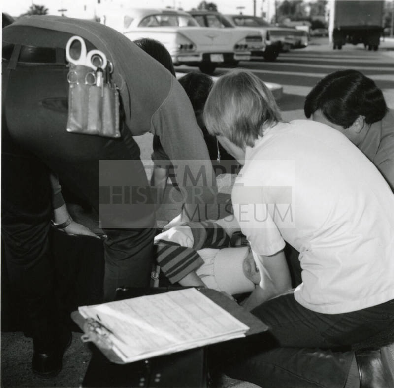 Paramedics assisting a female victim (3 of 3)