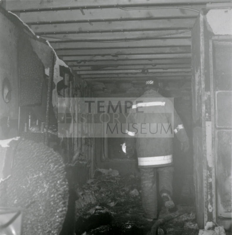 Fireman in a burned-out structure, February 1978