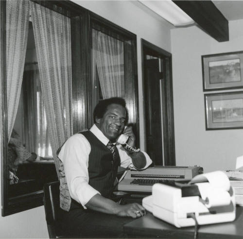 Prentice Williams Sitting at a Desk