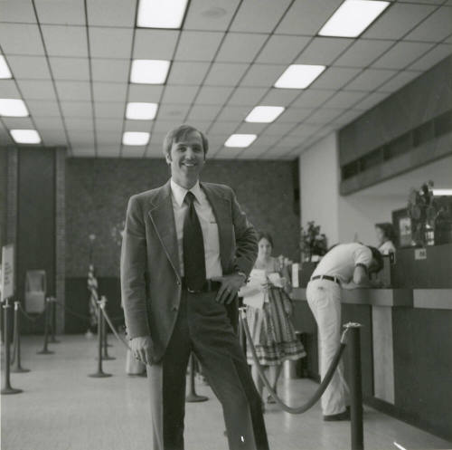 Unidentified Man Standing In Bank or Credit Union (1 of 2)