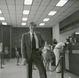 Unidentified Man Standing In Bank or Credit Union (1 of 2)