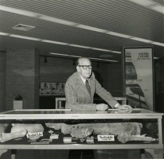 Professor with display case -- May 1978