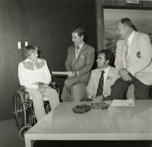 Young man in wheelchair with mayor and others -- April 1978