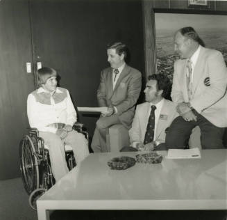 Young man in wheelchair with mayor and others -- April 1978
