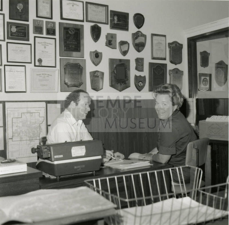 Man and woman sit at a desk  - June 1978