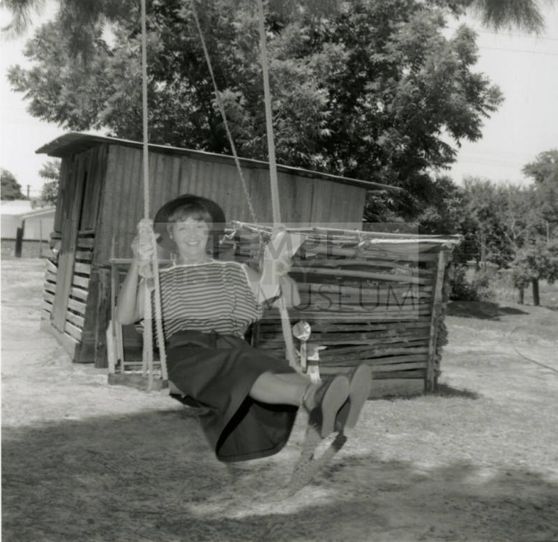 Woman Sits on Swing