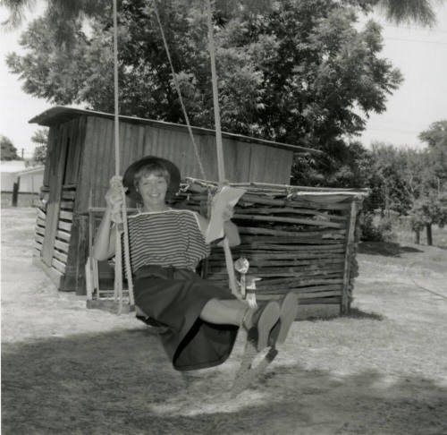 Woman Sits on Swing