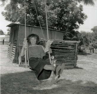 Woman Sits on Swing