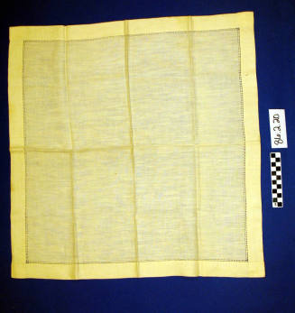 Eggshell white linen table scarf with eyelet trim by hems.