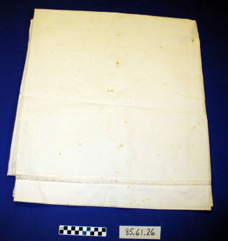 white sheet with crocheted floral motif border
