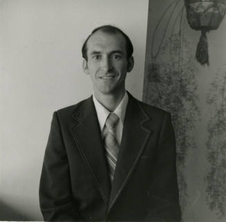 Unidentified Man in Dark Suit and Tie