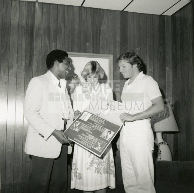 Unidentified Trio Holding Homecoming Sign