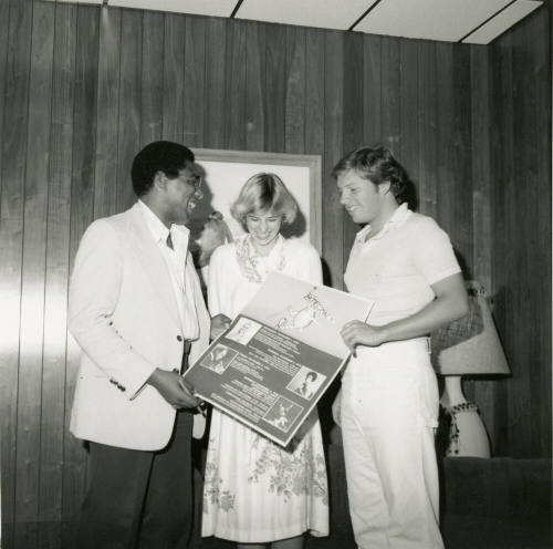 Unidentified Trio Holding Homecoming Sign