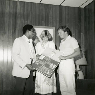 Unidentified Trio Holding Homecoming Sign