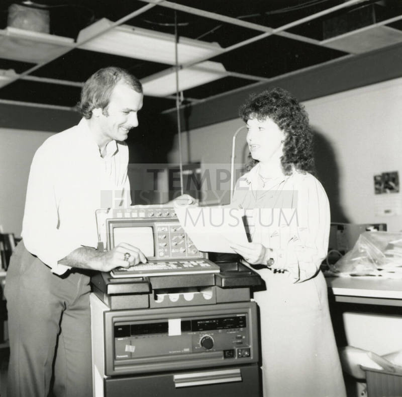 Unidentified Couple Discussing Electronic Device (EKG?)  - (1of 2)