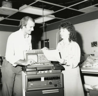 Unidentified Couple Discussing Electronic Device (EKG?)  - (1of 2)