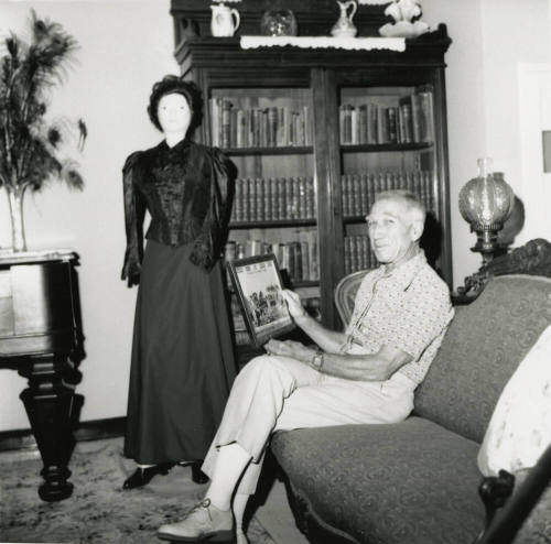 Unidentified Man In Antique Filled Room