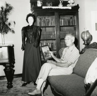 Unidentified Man In Antique Filled Room