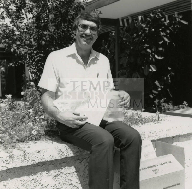 Unidentified Man Sitting On Planter
