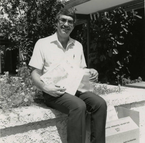 Unidentified Man Sitting On Planter