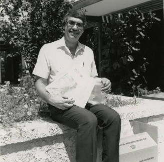 Unidentified Man Sitting On Planter