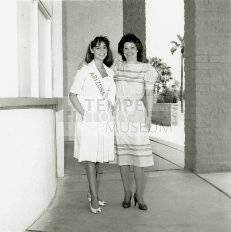 Two unidentified women standing in a breezeway