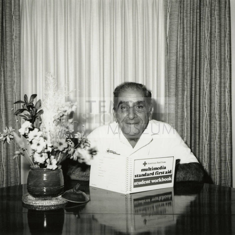 Unidentified Man Reading First Aid Workbook