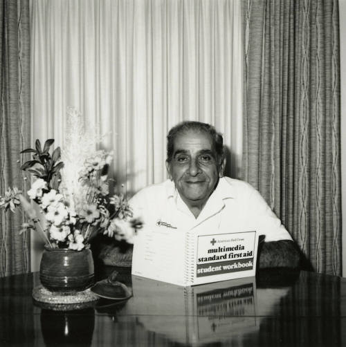 Unidentified Man Reading First Aid Workbook