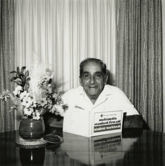 Unidentified Man Reading First Aid Workbook
