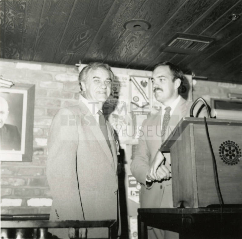 Unidentified Men Stand Behind Rotary International Podium